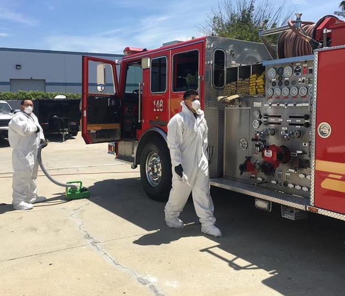 SERVPRO techs in full PPE's sanitizing our local fire truck