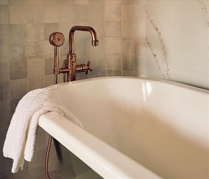 A bathtub with a brass faucet set
